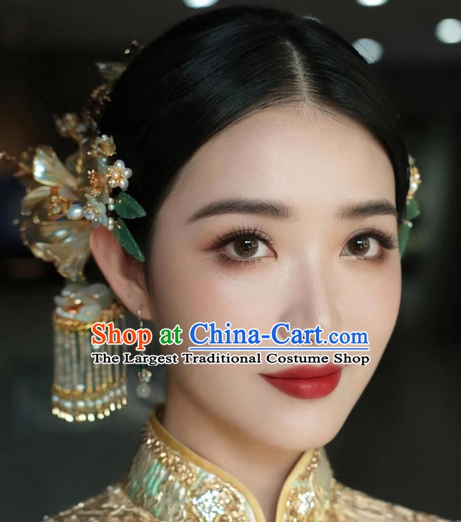 Elegant Chinese wedding hair styled with decorative hair sticks for a traditional bridal look