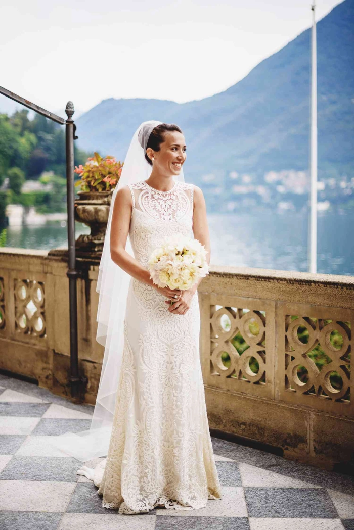 Elegant Edwardian wedding updo featuring intricate curls and floral accents
