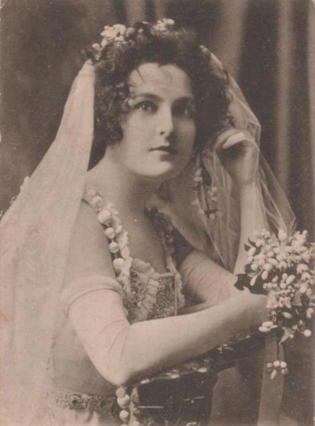 Elegant Edwardian wedding updo featuring intricate curls and vintage details