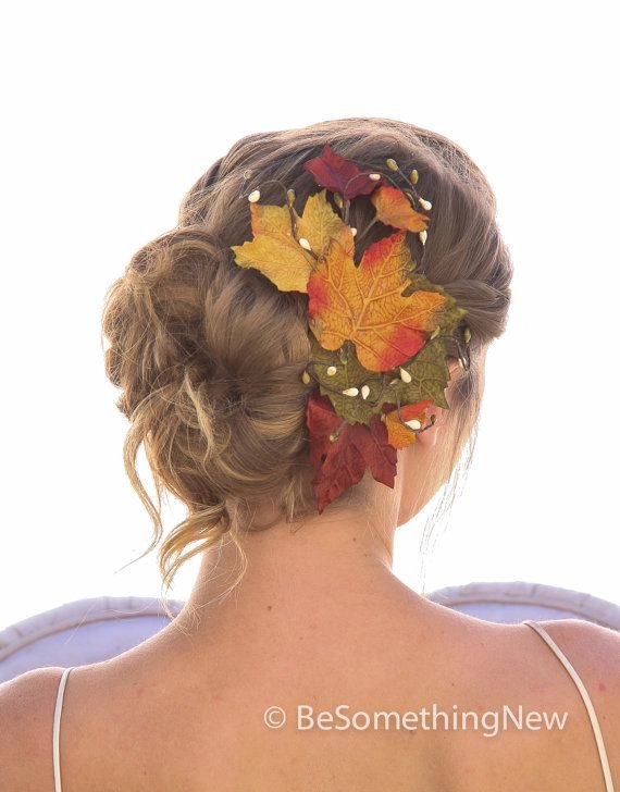 Elegant fall autumn wedding hair styled with delicate leaves woven throughout