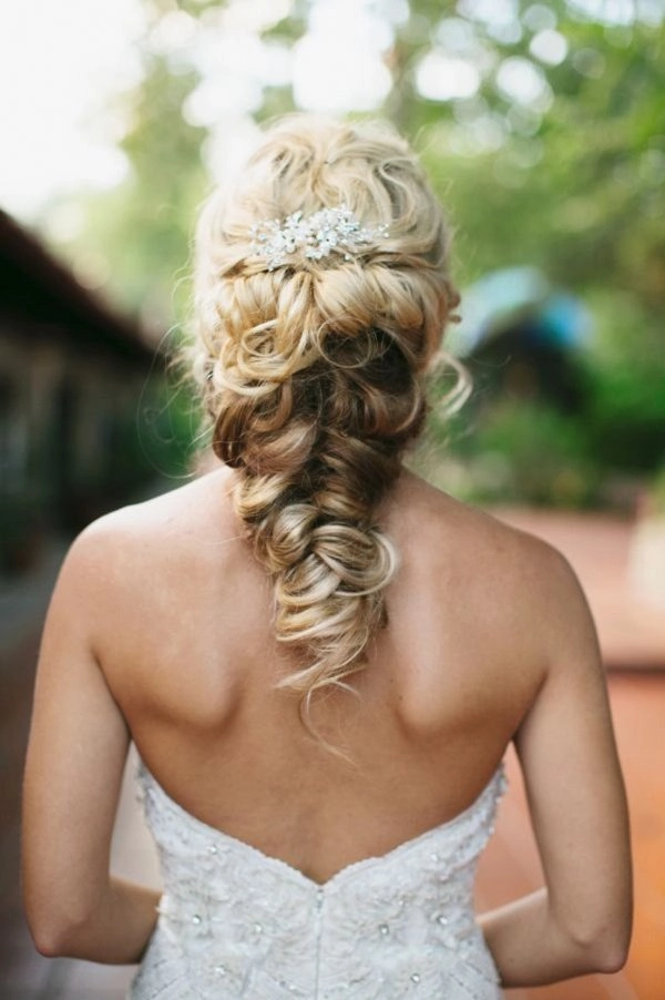 Romantic fishtail braid updo perfect for bridal hairstyles on wedding day Elegant wedding hair fishtail braid updo with intricate weaving and soft curls