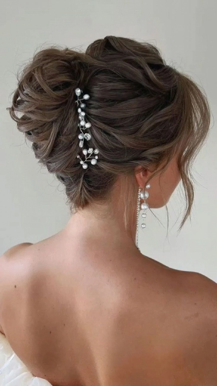 Elegant French twist bridal hair with soft curls and floral accessories