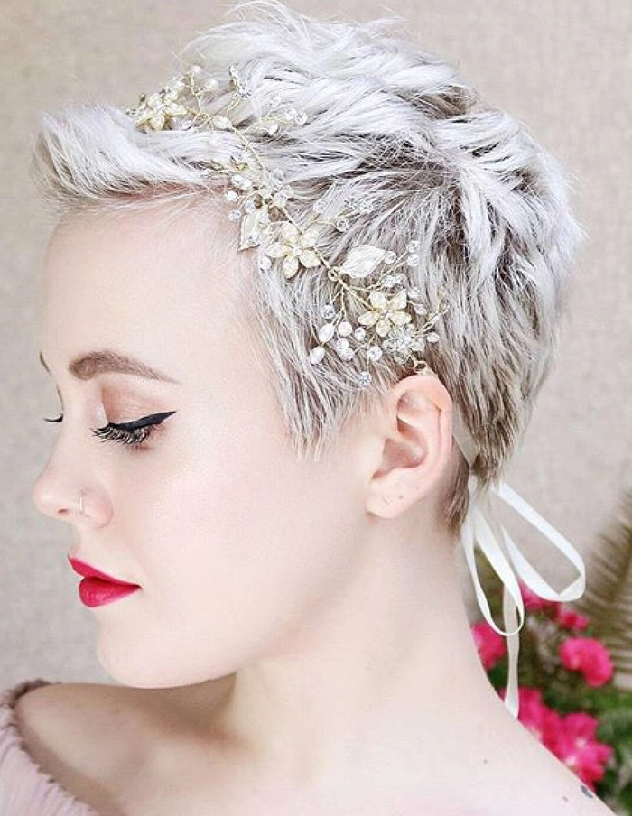 Chic bridal hairstyle featuring pixie cut with floral embellishments Elegant pixie cut adorned with delicate wedding hair accessories