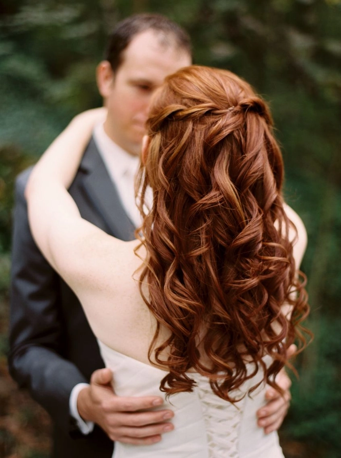 Elegant bridal hair for redheads with soft curls and floral accessories