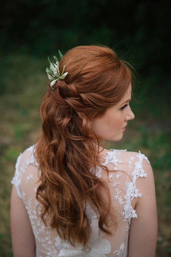 Elegant bridal hair for redheads styled in loose waves with floral accessories