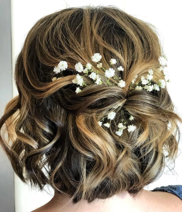 Chic short bob bridal hairstyle perfect for a modern wedding look Elegant short bob wedding hairstyle with delicate floral accessories for brides