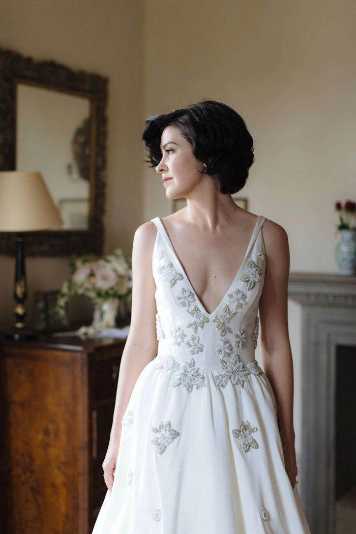 Elegant wedding hair for short layers with delicate floral accents