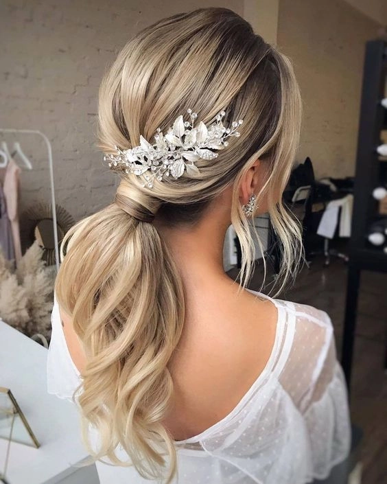 Short wedding hair with extensions showcasing a chic bridal hairstyle in image 5 Elegant short wedding hair styled with extensions for added volume and texture