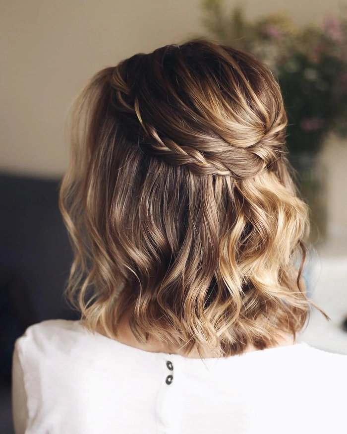 Elegant wedding hair for short layers styled with soft waves and delicate accessories