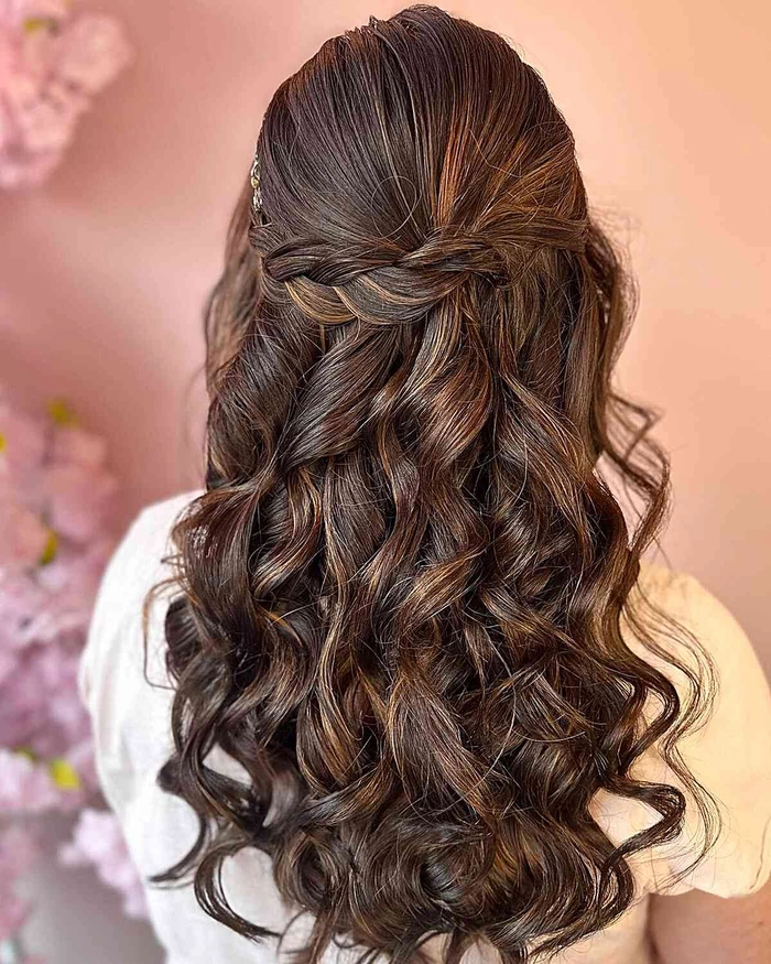 Chic hairstyle perfect for summer wedding guests in outdoor settings Elegant summer wedding guest hair with soft curls and floral accessories