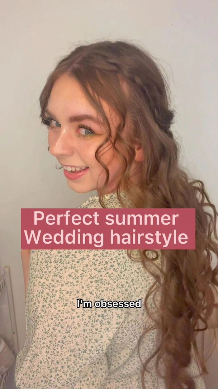 Chic summer wedding guest hair inspiration for outdoor ceremonies Elegant summer wedding guest hairstyle with soft curls and floral accessories