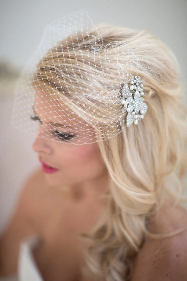 Elegant wedding hairstyle featuring a classic birdcage veil for a vintage bridal look