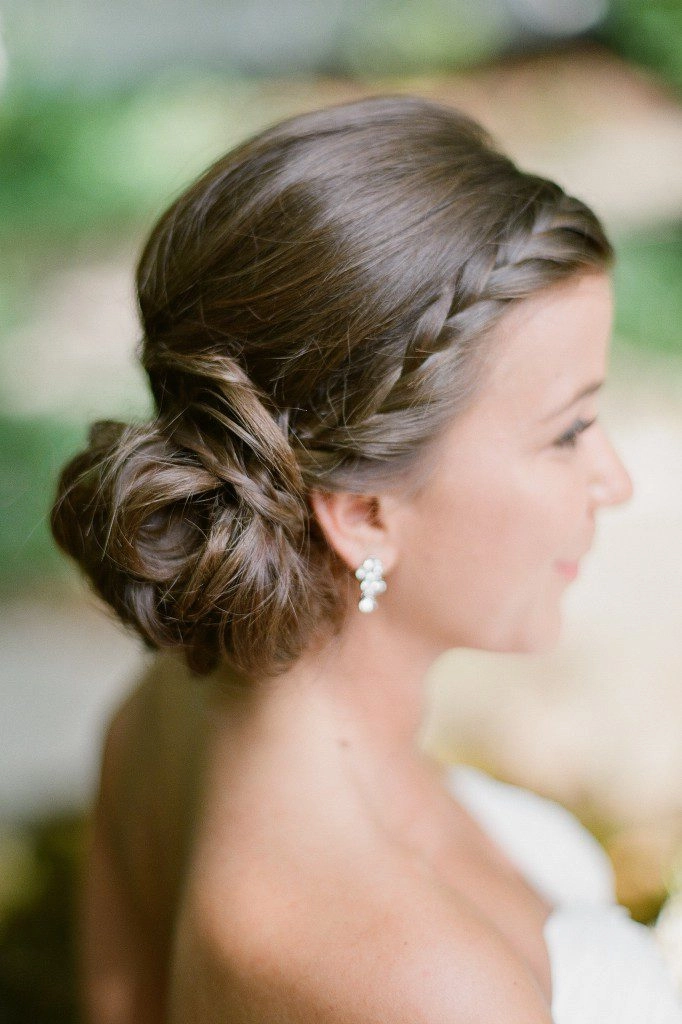 Classic bridal hairstyle featuring a stylish knot updo for weddings Elegant wedding hair knot updo with delicate floral accents
