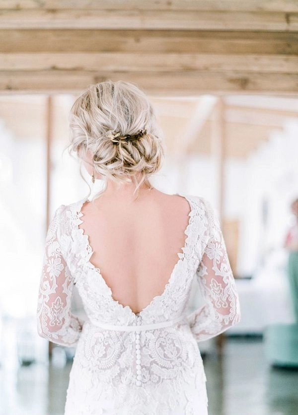 Chic wedding hairstyle perfect for showcasing a backless gown on your special day Elegant wedding hair styled to complement a backless dress with soft curls and a delicate hair accessory