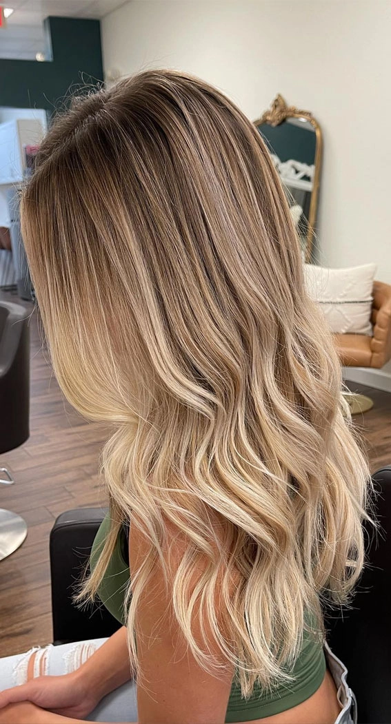Elegant wedding hair styled for blonde balayage with soft curls