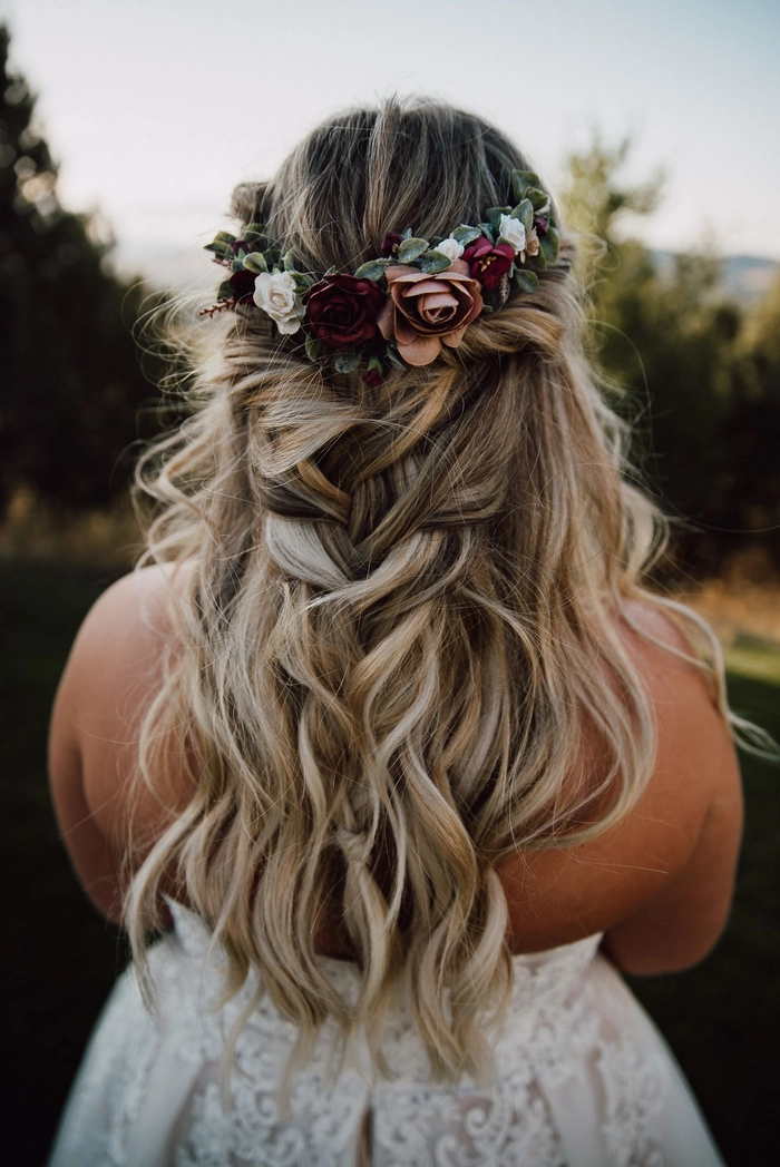 Stylish bridal hairstyle featuring a delicate braided crown for weddings Elegant wedding hair braided crown with soft romantic waves