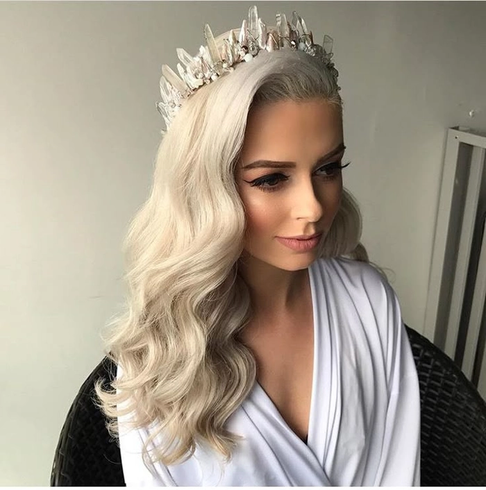 Stunning wedding hairstyle featuring a sparkling crystal tiara for brides Bride showcasing elegant wedding hair with crystal tiara for a timeless look