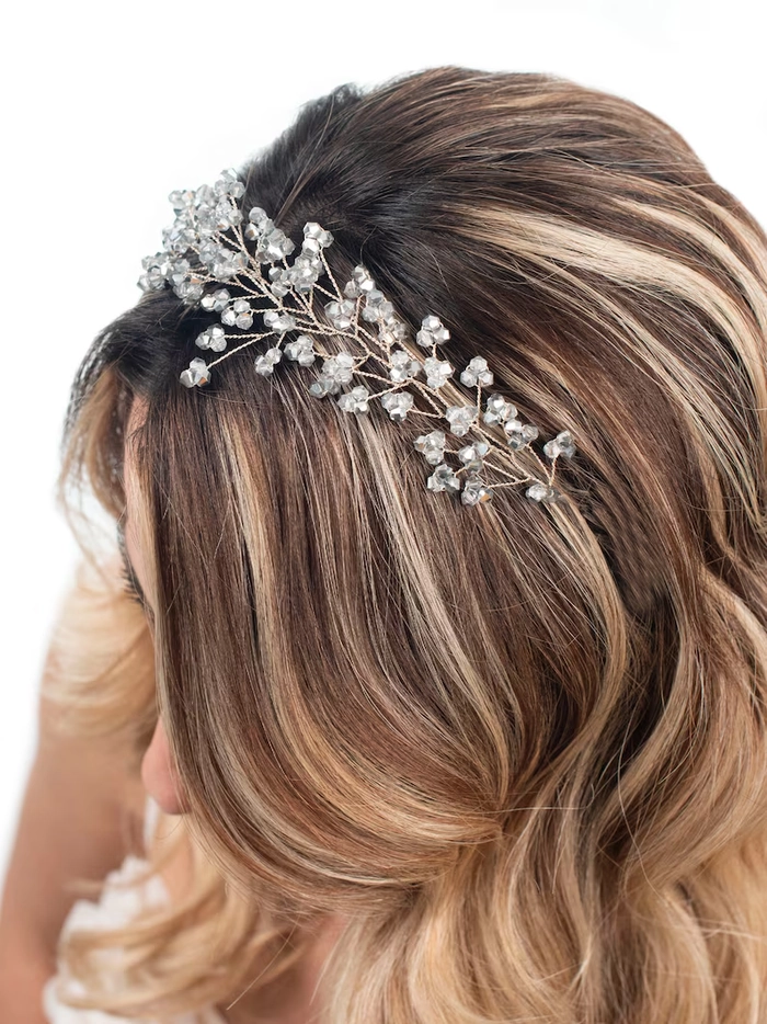 Graceful bridal hairstyle featuring a sparkling crystal tiara for weddings Elegant wedding hair styled beautifully with a crystal tiara for a bridal look