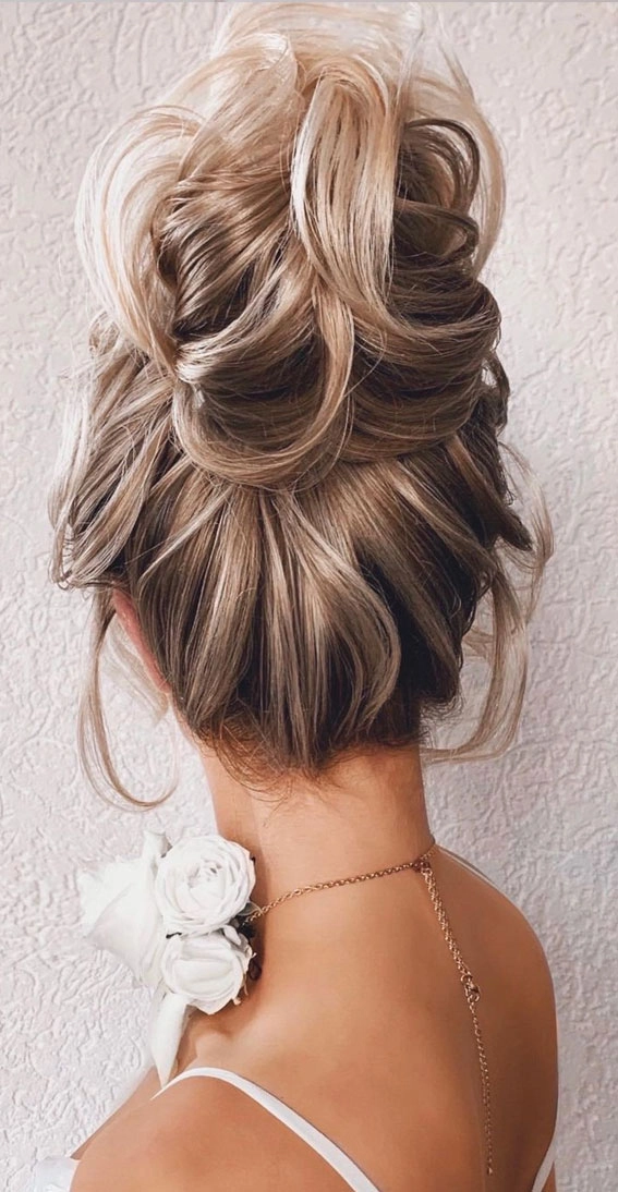Classic bridal hairstyle featuring a beautifully styled hair knot updo for weddings Elegant wedding hair knot updo adorned with delicate floral accents