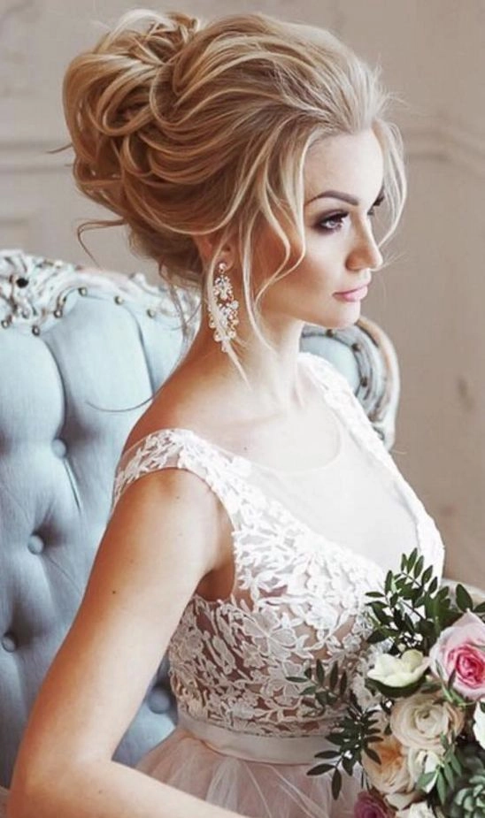 Beautiful bridal hairstyle featuring a sophisticated knot updo for weddings Elegant wedding hair knot updo with delicate floral accents