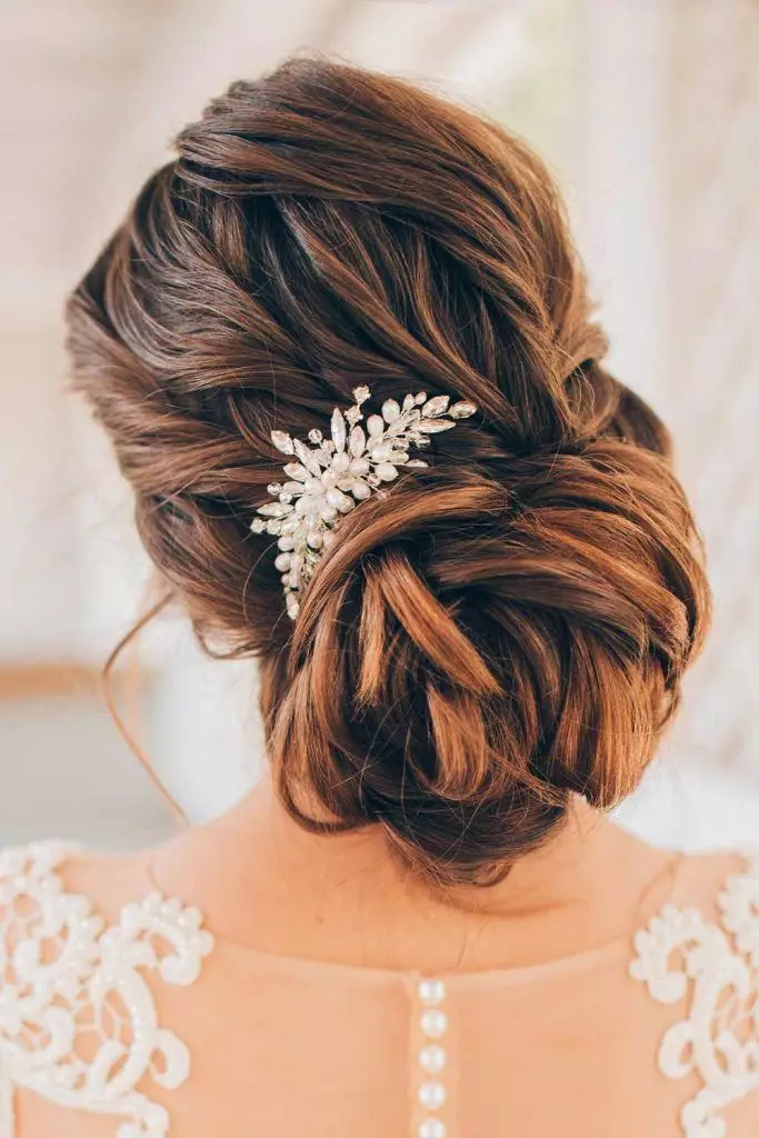 Beautiful bridal wedding hair knot updo perfect for a classic ceremony look Elegant wedding hair knot updo styled with delicate curls and floral accessories