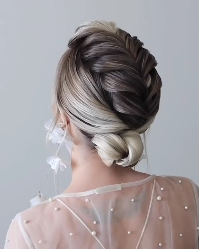 Elegant wedding hair with bangs styled in loose curls