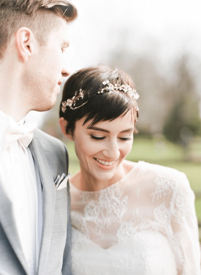 Elegant wedding hair styled for short layers with soft curls and delicate accessories