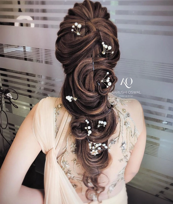 Elegant evening reception wedding hair changes with soft curls and floral accessories