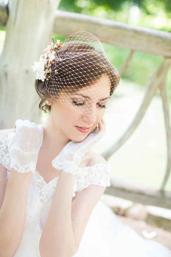 Elegant wedding hairstyle featuring a delicate birdcage veil for a timeless bridal look