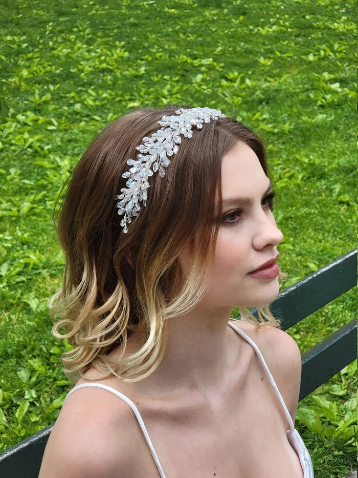 Wedding hairstyle inspiration with a sparkling crystal tiara accessory Elegant wedding hairstyle featuring a crystal tiara on styled hair