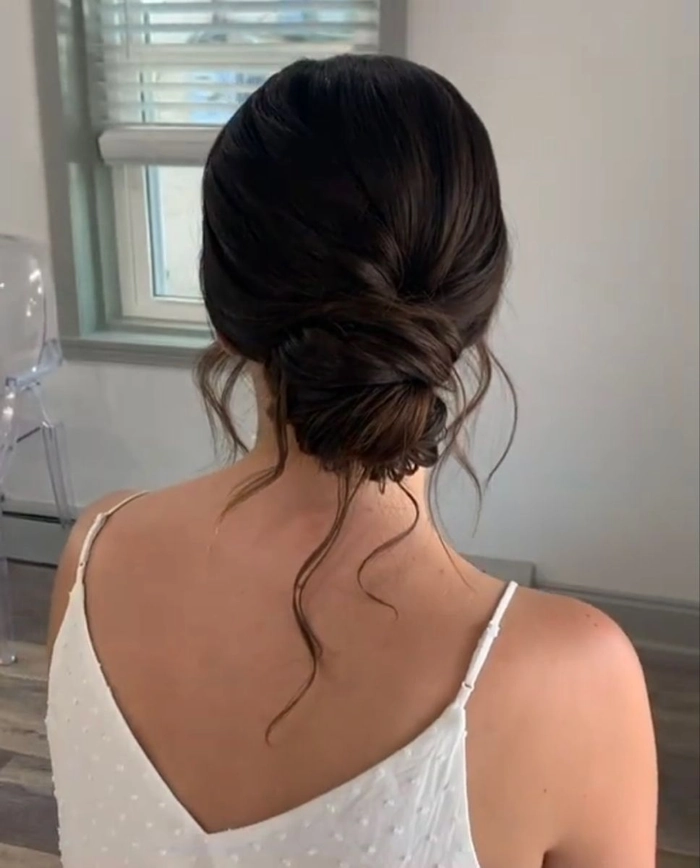 Wedding hair inspiration for a graceful backless gown look Elegant wedding hairstyle showcasing delicate curls for a backless dress