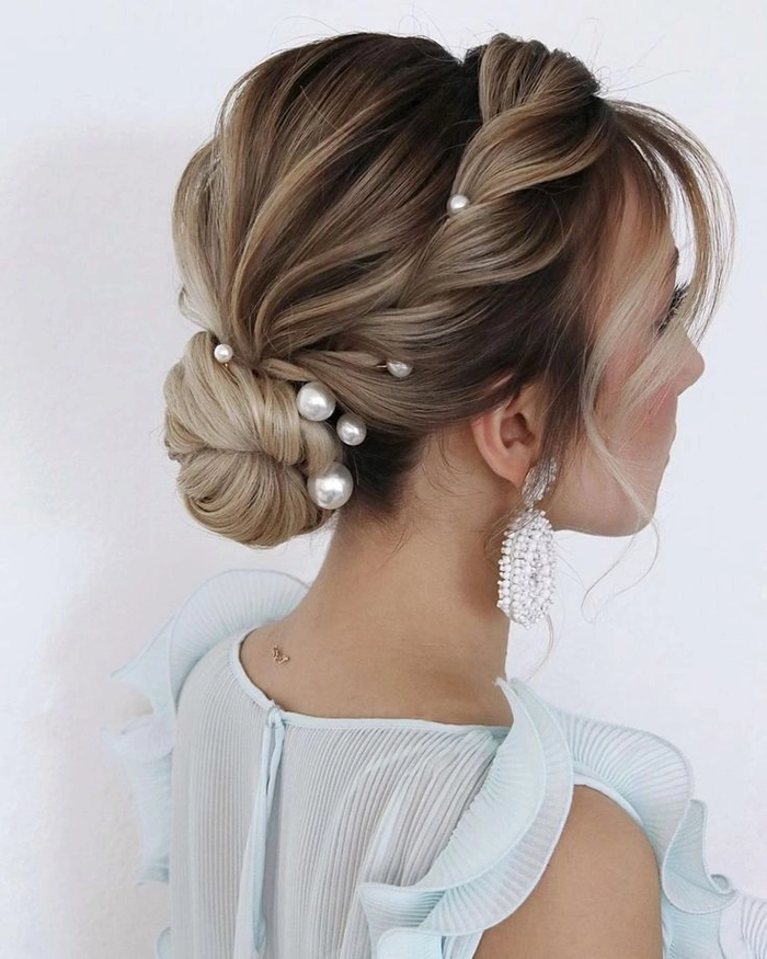 Elegant wedding hairstyle featuring soft bangs and loose curls