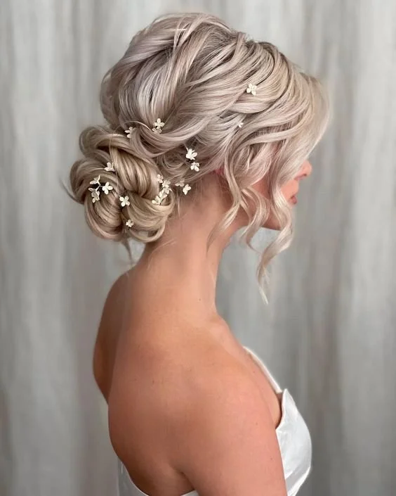 Thick coarse hair styled beautifully for a bride on her wedding day Elegant wedding hairstyle for thick coarse hair with soft waves and floral accessories