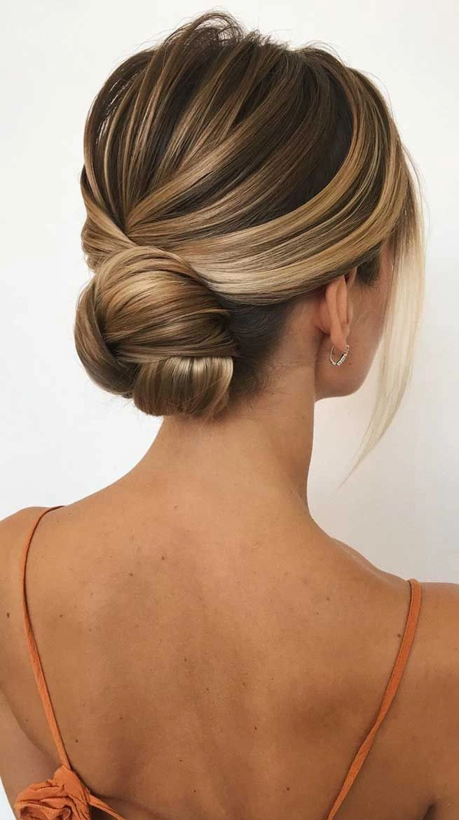 Beautiful twisted low bun hairstyle perfect for weddings and special occasions Elegant wedding hair twisted into a low bun with soft, romantic waves