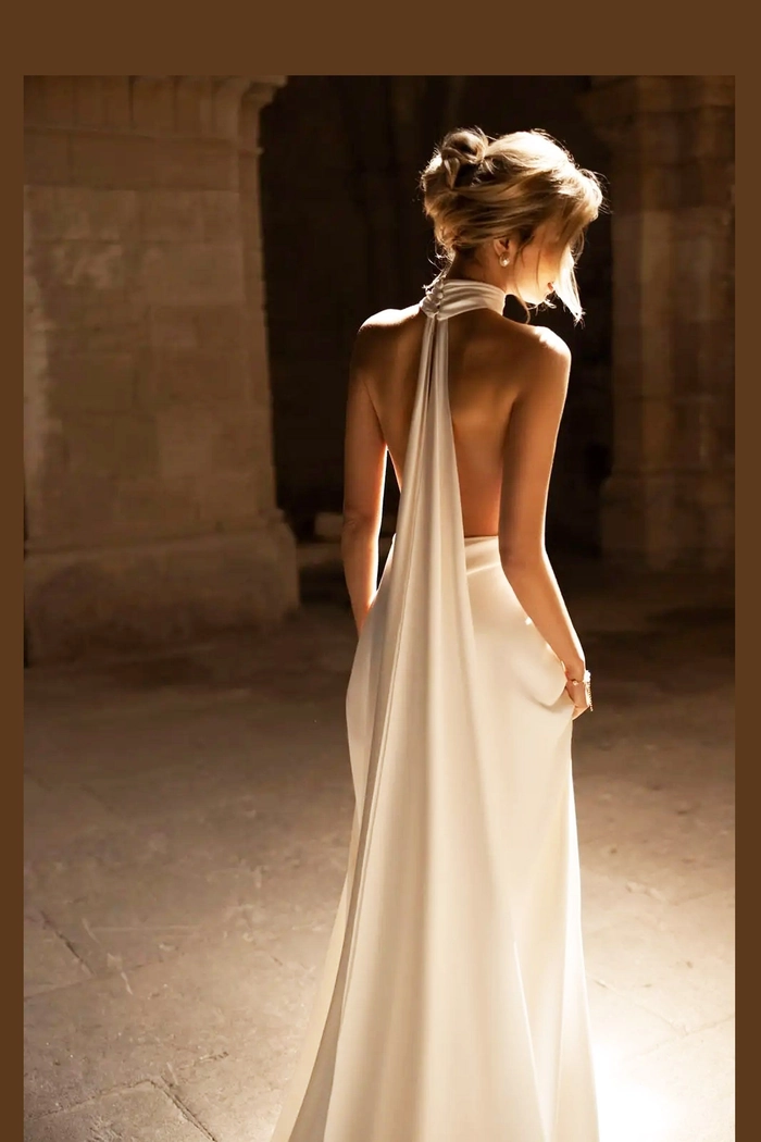 Romantic bridal hair for a backless wedding gown inspiration Elegant wedding hairstyle showcasing soft curls perfect for a backless dress