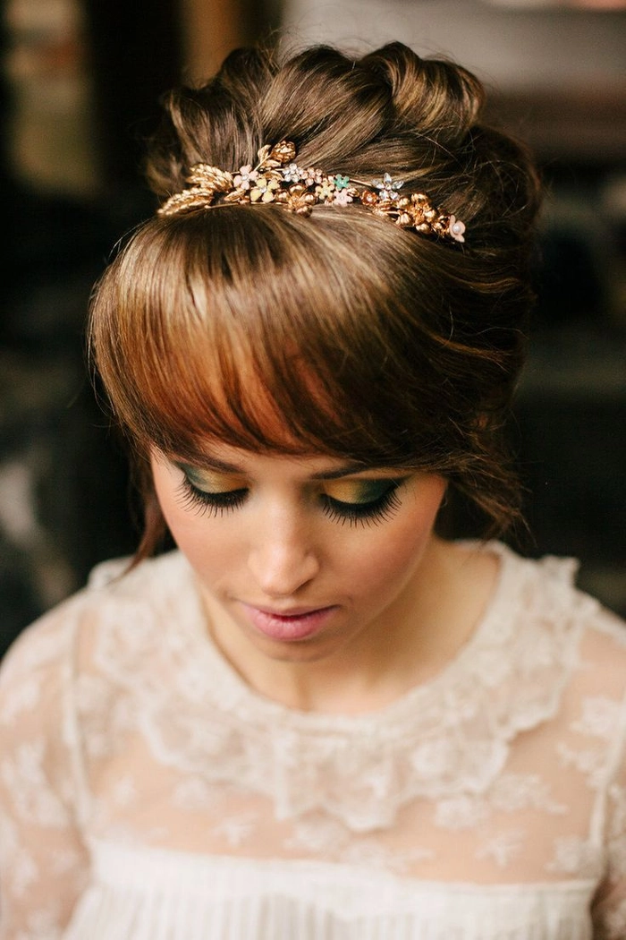 Elegant wedding hairstyle featuring soft waves and delicate bangs