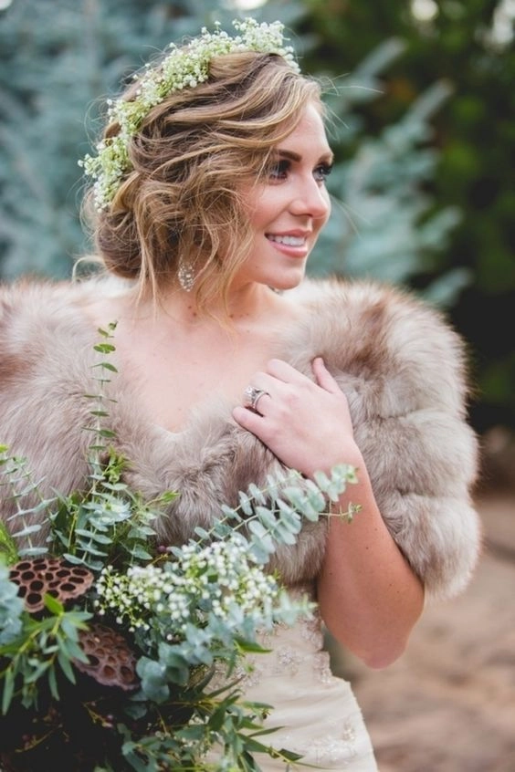 Elegant winter wedding hairstyle featuring faux fur accessories