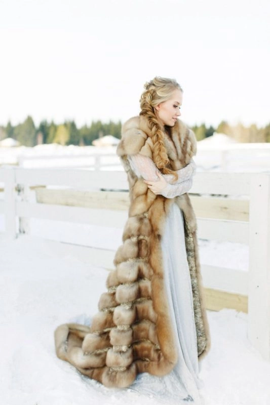 Elegant winter wedding hairstyle adorned with soft faux fur accessories for a cozy bridal look