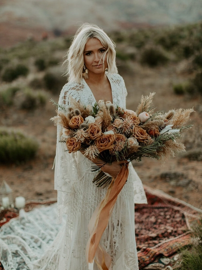 Elegant wedding hairstyle idea for intimate ceremonies and elopements Elopement bridal hair style featuring loose waves with floral accents