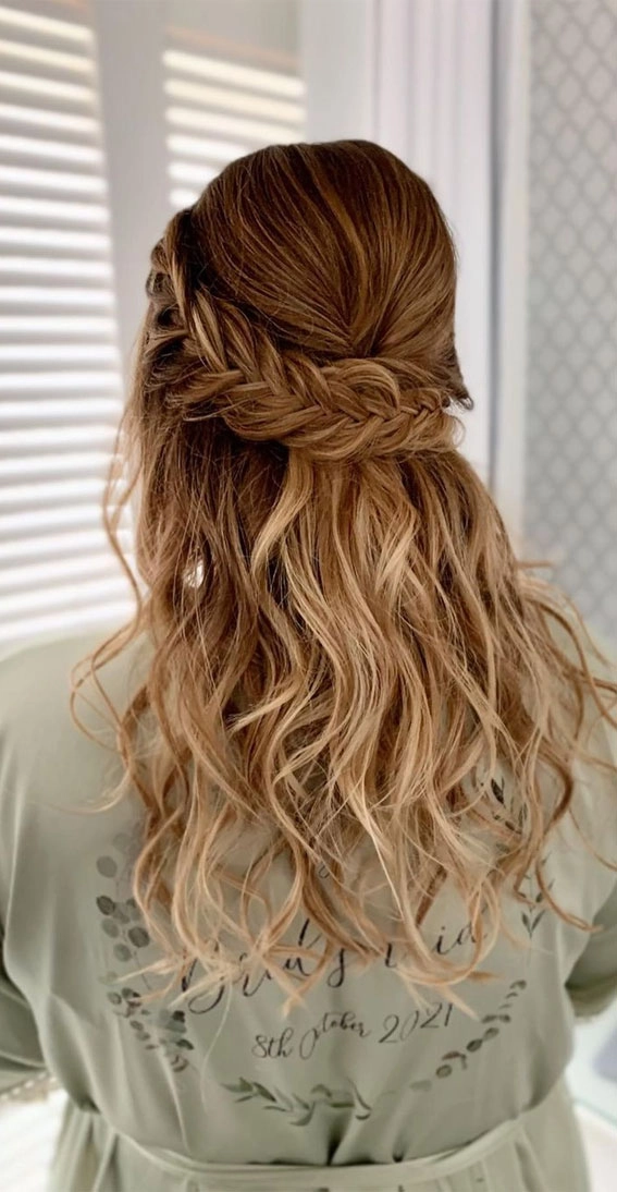 Stunning fishtail braid updo perfect for a romantic wedding look Elegant wedding hairstyle featuring a fishtail braid updo with delicate floral accents