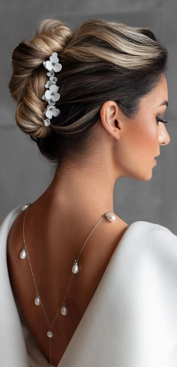 Elegant French twist bridal hair hairstyle with soft curls and delicate accessories