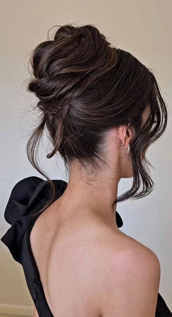 Elegant French twist bridal hair styled with delicate floral accents for a wedding