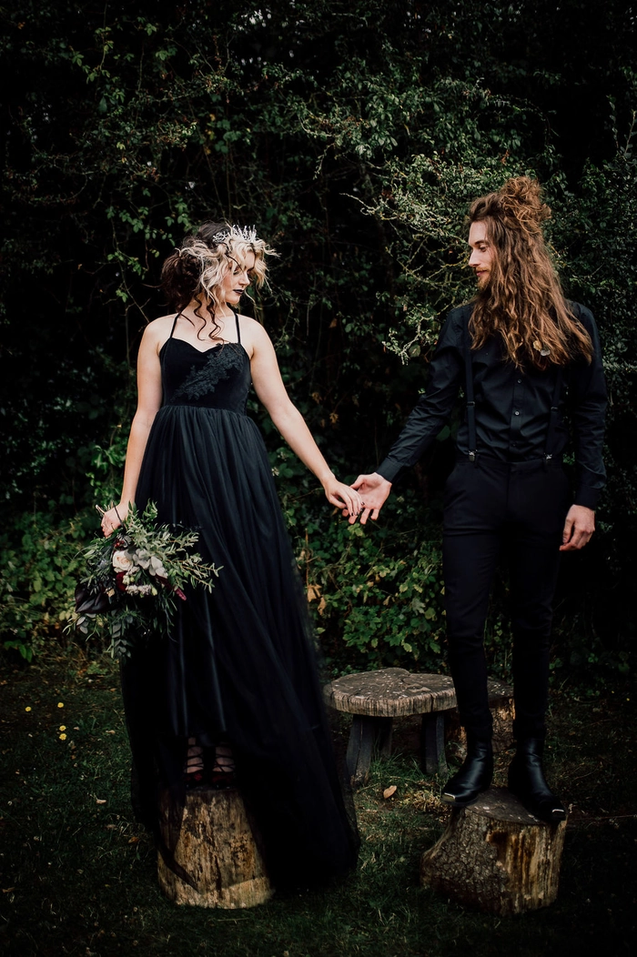 Stunning bridal hairstyle for a gothic-themed wedding celebration Elegant gothic wedding bridal hair with dark, intricate twists and floral accents