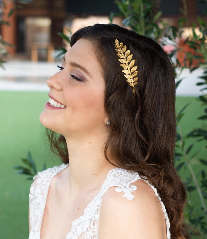 Bride showcasing elegant Greek wedding hair with olive wreath