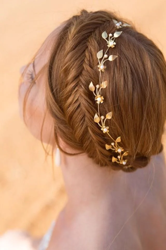 Elegant Greek wedding hair adorned with a delicate olive wreath for a bride