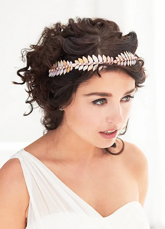 Elegant Greek wedding hairstyle adorned with a delicate olive wreath
