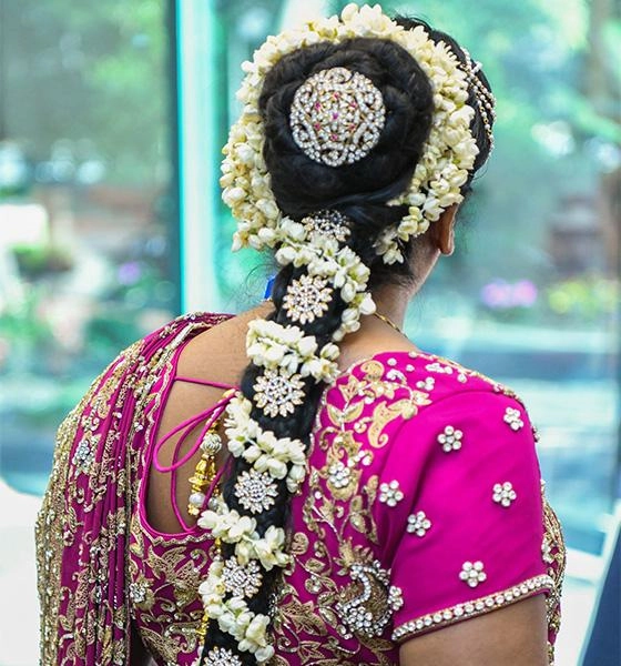 Elegant wedding hairstyle featuring classic gajra for Indian brides Traditional Indian bridal hairstyle adorned with fresh white gajra flowers