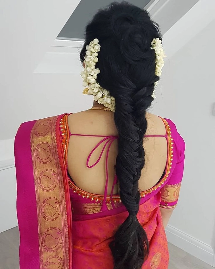 Elegant wedding hairstyle featuring a classic gajra decoration for Indian brides Traditional Indian bridal hairstyle adorned with fresh jasmine gajra flowers