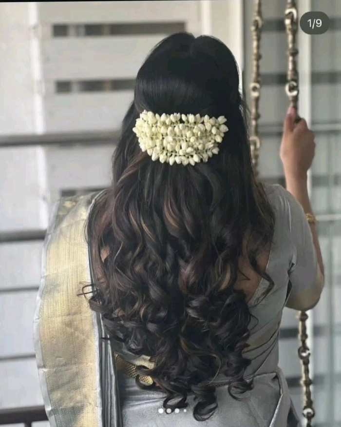Elegant wedding hairstyle featuring traditional Indian bridal gajra decoration Traditional Indian bridal hairstyle adorned with white jasmine gajra flowers