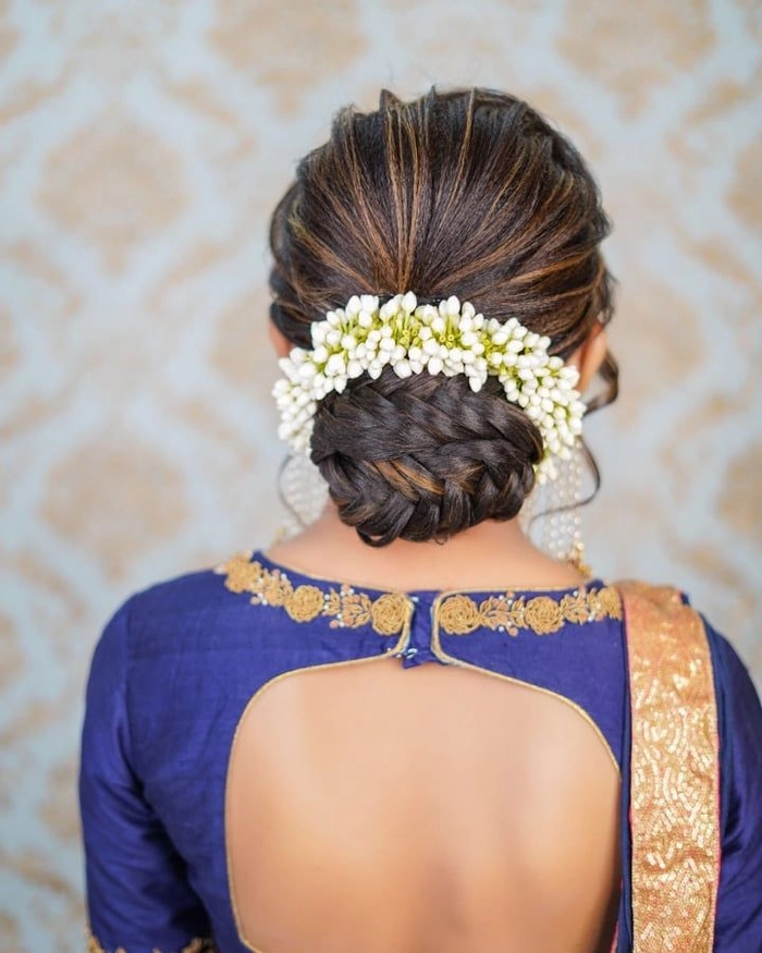 Elegant wedding hairstyle featuring classic gajra decoration for brides Traditional Indian bridal hairstyle adorned with white jasmine gajra flowers